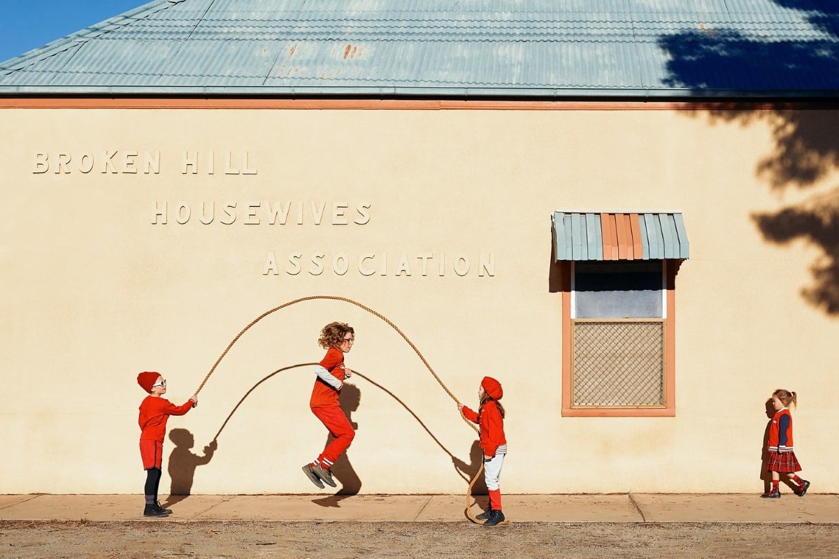 Kids jumping rope in front of a building