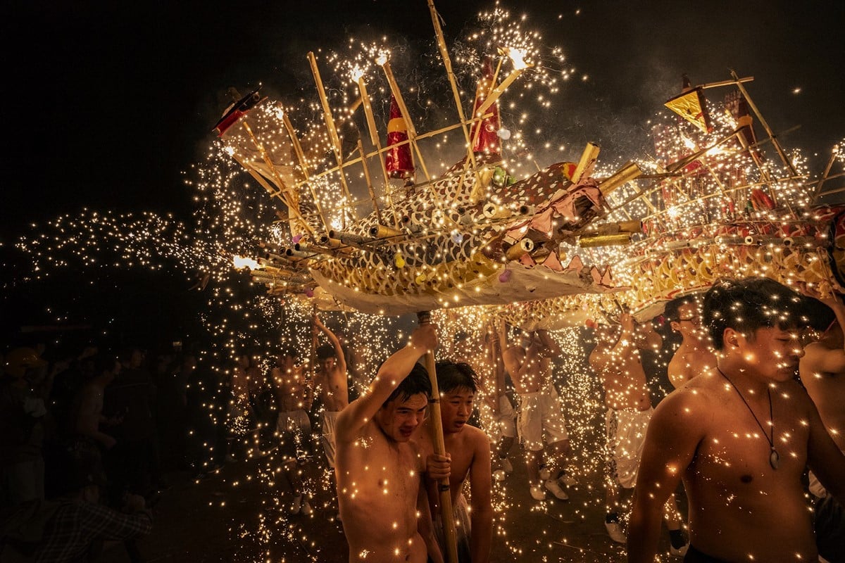 Showered by molten, firework-like sparks, people in Meizhou, China performa fire dragon dance to celebrate the Lantern Festival on the first full moon of the Lunar Calendar